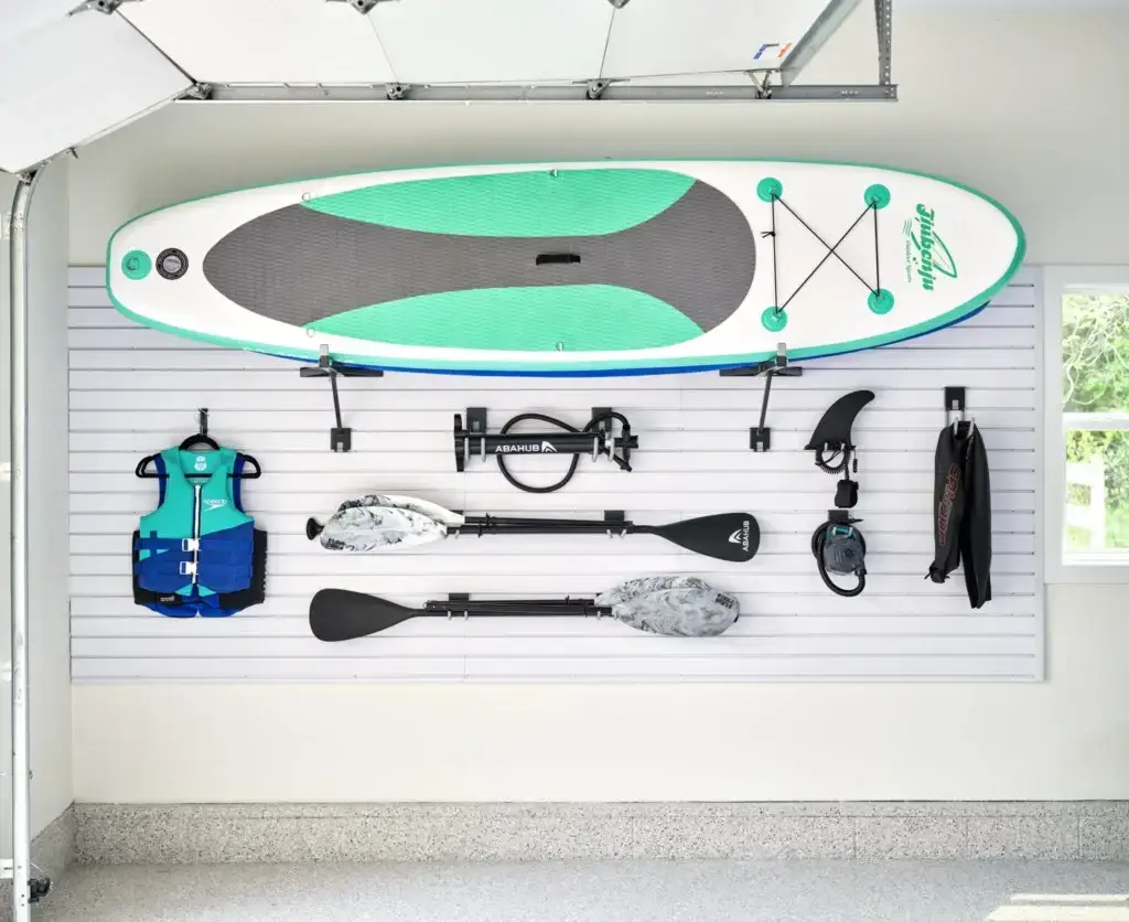 Image showing kayak, paddles, and other gear stored on the wall.