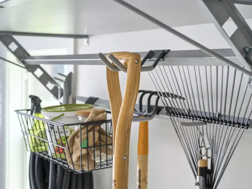 Image showing various gardening implements hanging on different types of hooks