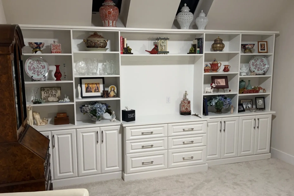 Custom built-in wall unit with shelving, cabinets, and a designated space for a TV or display